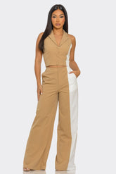 Woman wearing beige and white color block sleeveless crop top and wide-leg pants fashion outfit