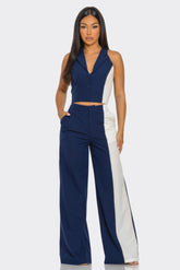 Woman in blue and white sleeveless blazer crop top and matching wide-leg pants fashion outfit