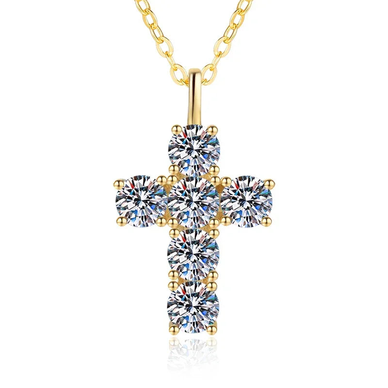 Gold cross pendant necklace with clear gemstones on a white background