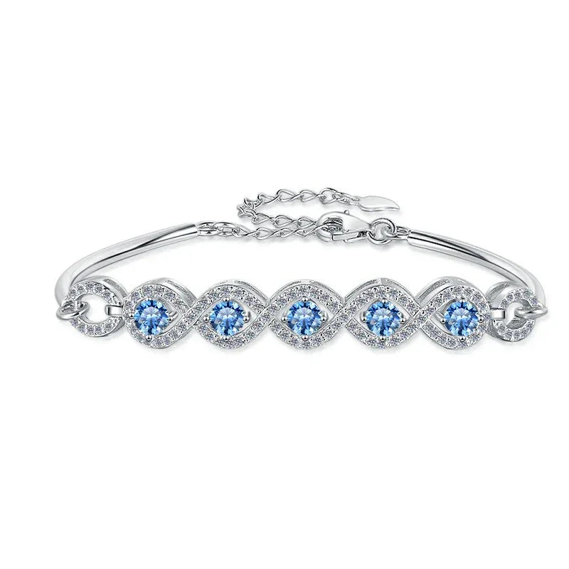 Silver bracelet with blue gemstones on a white background
