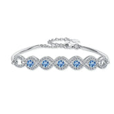 Silver bracelet with blue gemstones on a white background