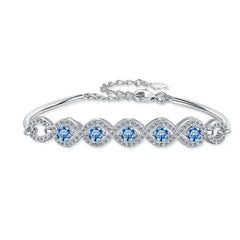 Silver bracelet with blue gemstones on a white background