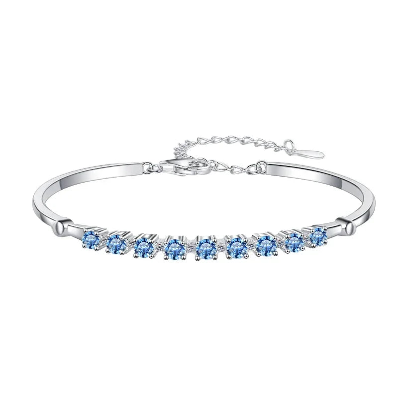 Silver bracelet with blue gemstones on a white background