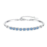 Silver bracelet with blue gemstones on a white background