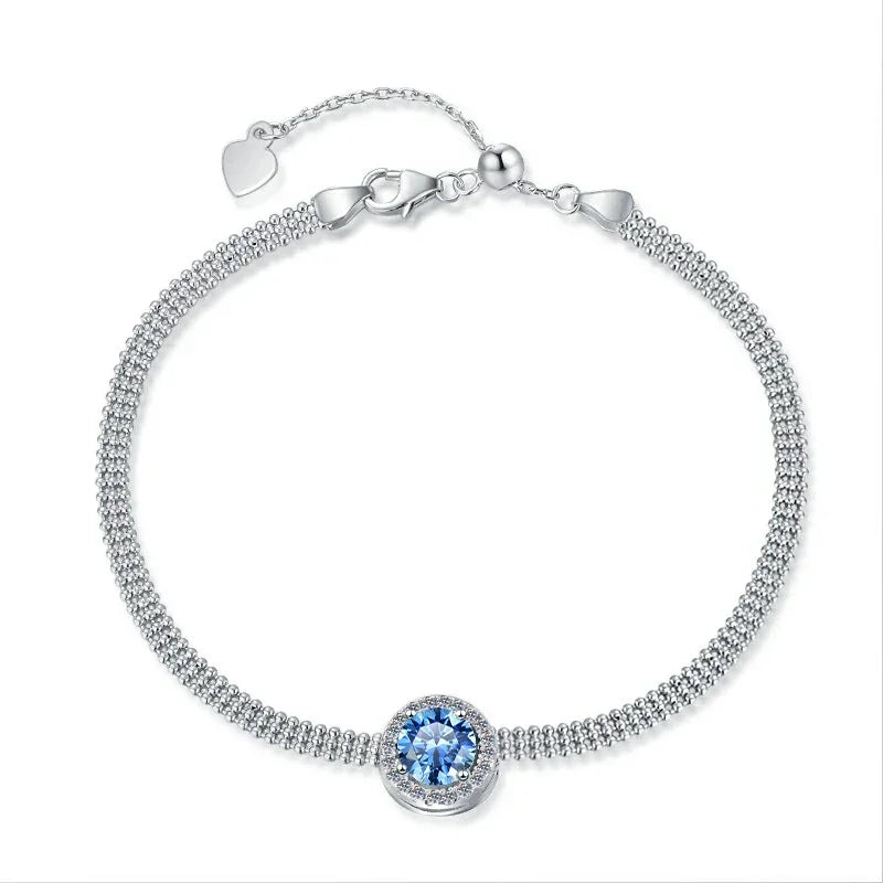 Silver bracelet with a blue gemstone on a white background