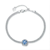 Silver bracelet with a blue gemstone on a white background