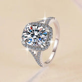 Silver ring with a large diamond on a beige background
