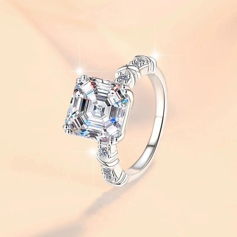 Silver ring with a large diamond on a soft pink background