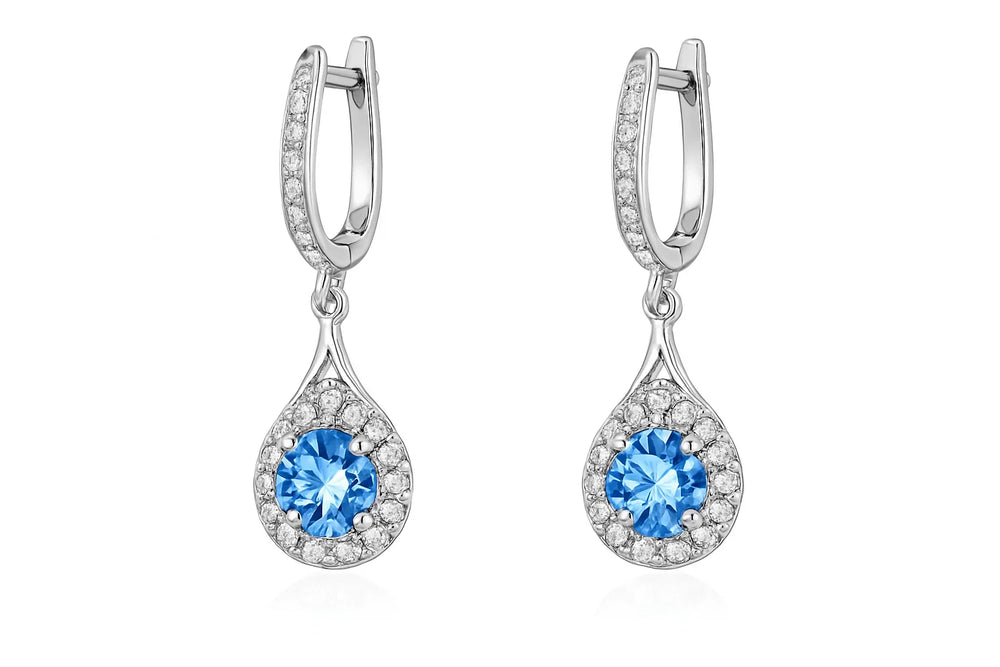 Pair of silver earrings with blue gemstones on a white background