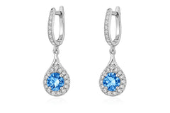 Pair of silver earrings with blue gemstones on a white background