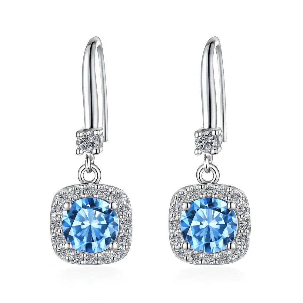 Silver earrings with blue gemstones on a white background