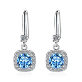 Silver earrings with blue gemstones on a white background