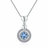 Silver necklace with a heart pendant and blue gemstone on a white background