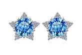 Star-shaped earrings with blue gemstones on a white background