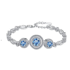 Silver bracelet with blue gemstones on a white background