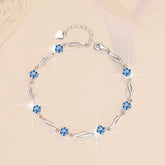 Silver bracelet with blue gemstones on a beige background