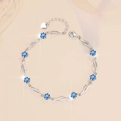 Silver bracelet with blue gemstones on a beige background