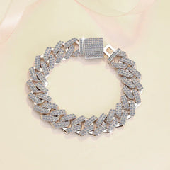 Silver chain bracelet with diamond-like stones on a light pink background