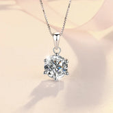 Silver necklace with a round diamond pendant on a soft beige background