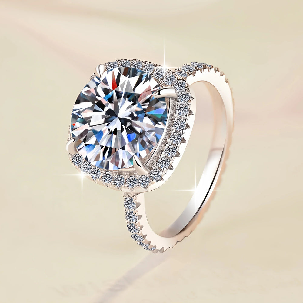 Silver ring with a large diamond on a beige background