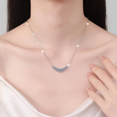 Necklace with a blue gemstone on a model against a neutral background