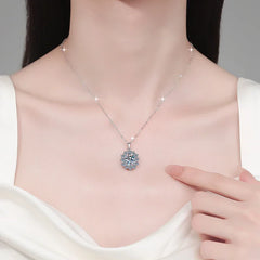 Necklace with a floral pendant worn by a person, against a neutral background