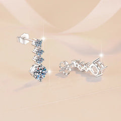 Silver earrings with gemstones on a beige background