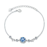 Silver bracelet with a blue gemstone on a white background