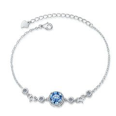 Silver bracelet with a blue gemstone on a white background