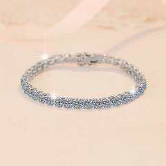 Silver bracelet with clear stones on a beige background