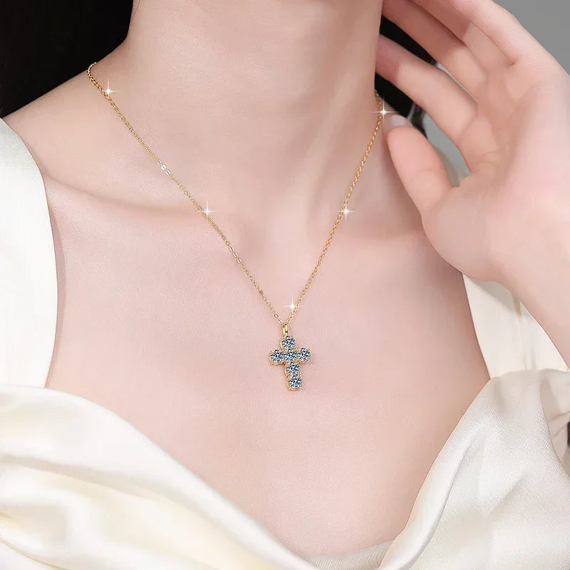 Gold necklace with a cross pendant worn by a person