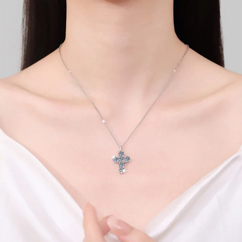 Necklace with a cross pendant worn by a person against a neutral background