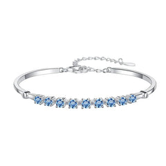 Silver bracelet with blue gemstones on a white background