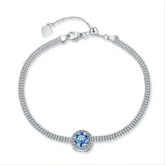 Silver bracelet with a blue gemstone on a white background