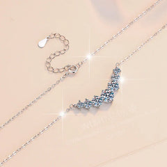 Silver bracelet with a floral diamond pendant on a beige background