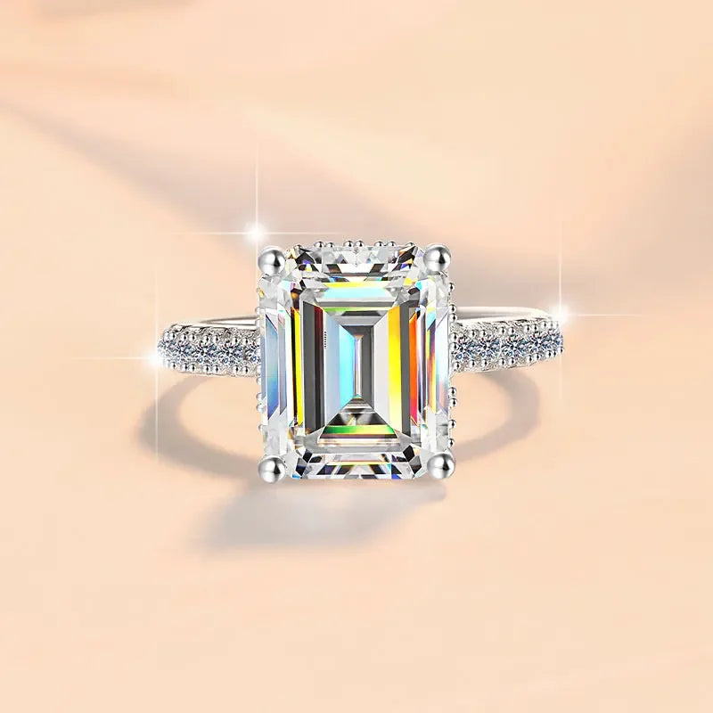 Diamond ring with a colorful gemstone on a peach background
