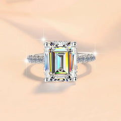 Diamond ring with a colorful gemstone on a peach background