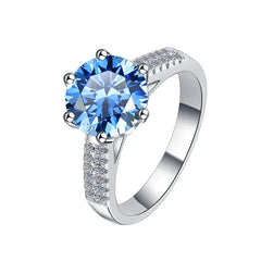 Silver ring with a blue gemstone on a white background