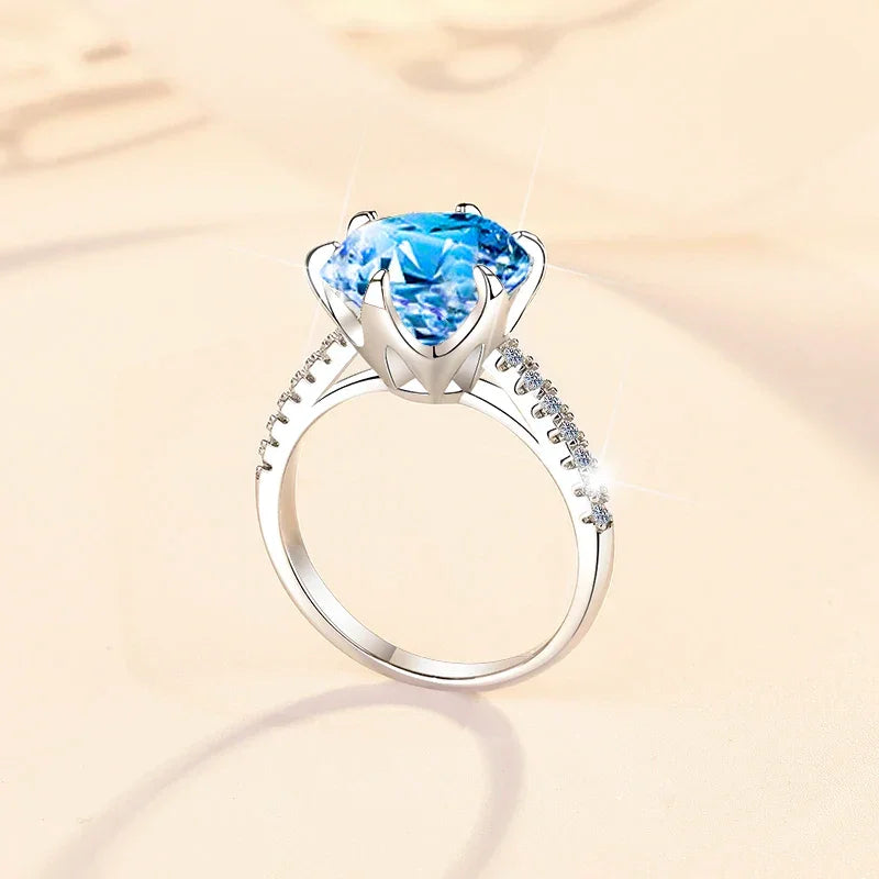 Silver ring with a blue gemstone on a beige background
