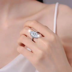 Hand wearing a sparkling 5ct marquise moissanite ring in 925 silver, elegant wedding anniversary jewelry