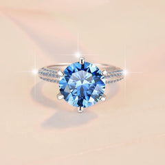 Ring with a blue gemstone on a beige background