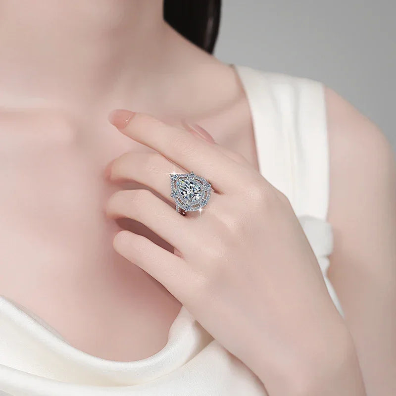 Close-up of a hand wearing a diamond ring on a neutral background