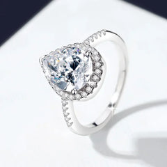 Silver ring with a large diamond on a white background