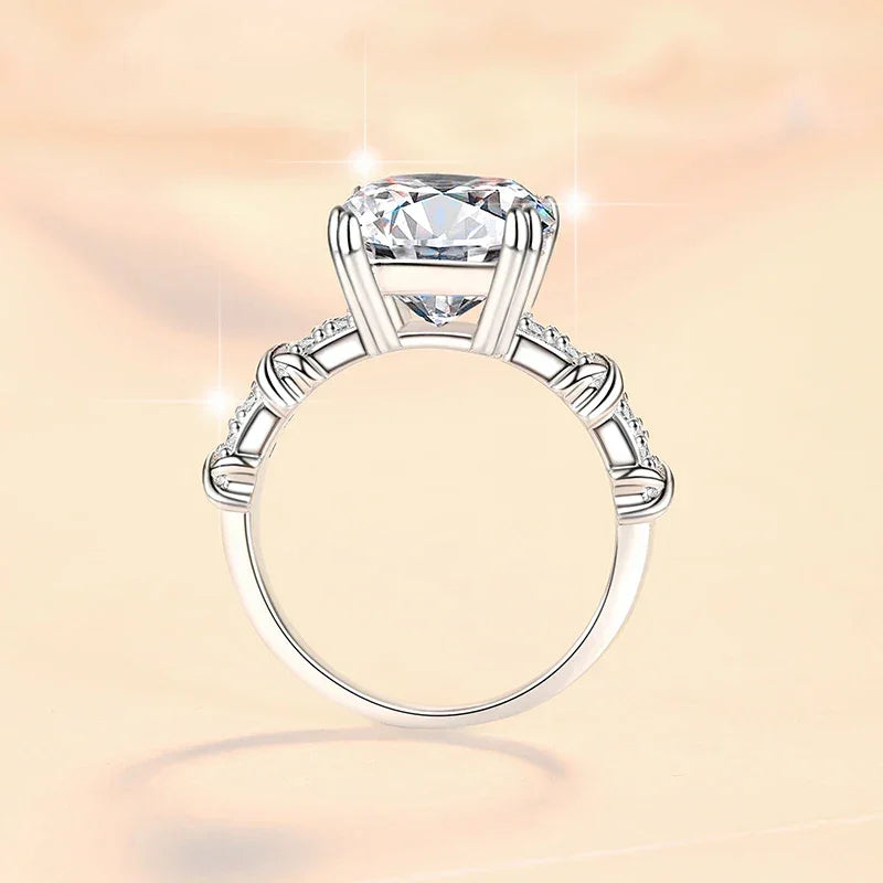 Silver ring with a large diamond on a soft pink background