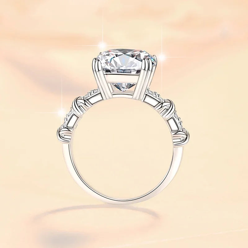 Silver ring with a large diamond on a soft pink background