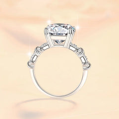 Silver ring with a large diamond on a soft pink background