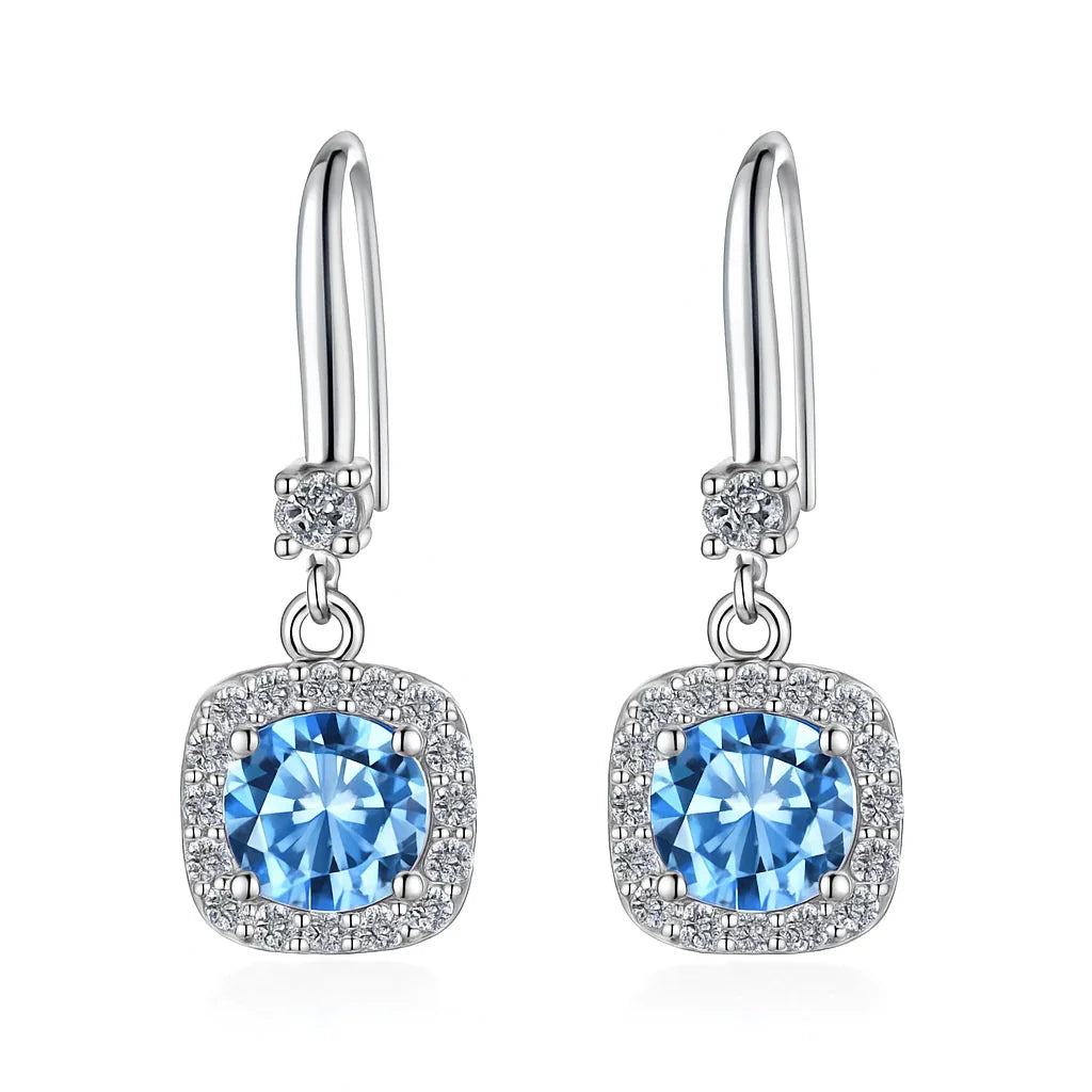 Silver earrings with blue gemstones on a white background