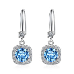 Silver earrings with blue gemstones on a white background