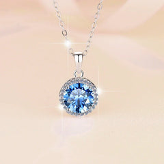 Silver necklace with a blue gemstone pendant on a soft beige background
