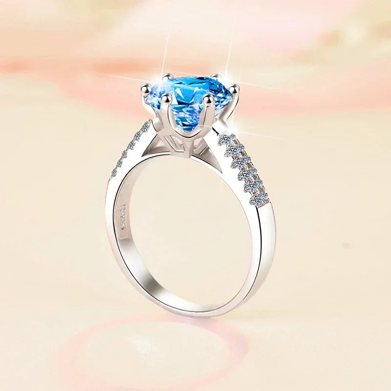 Silver ring with a blue gemstone on a soft, blurred background